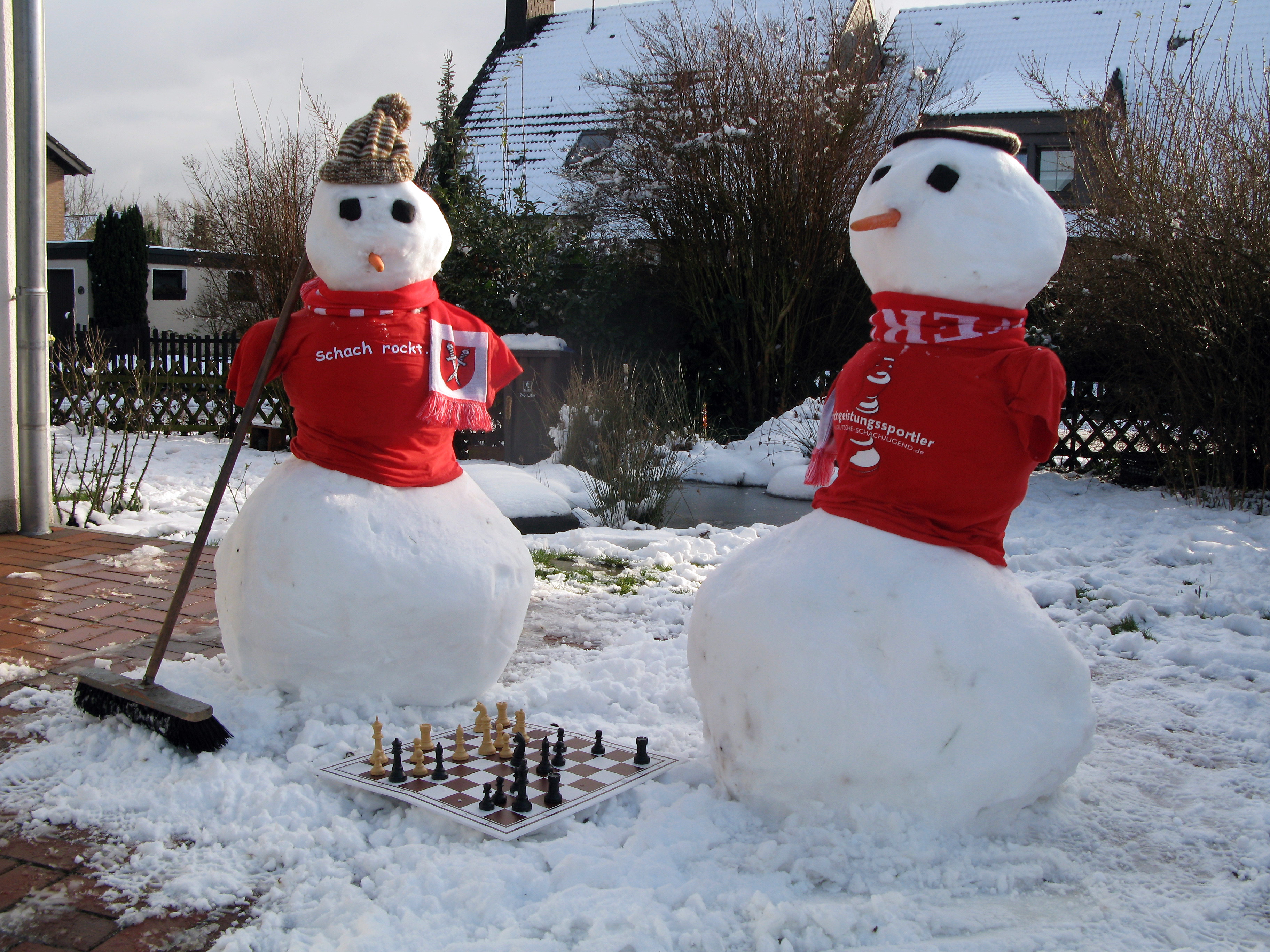 Schneemänner mit "Schach rockt."-T-Shirts